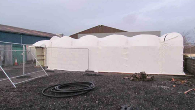 Covered walkway between two buildings in a pharmaceutical site.  Gallery Image