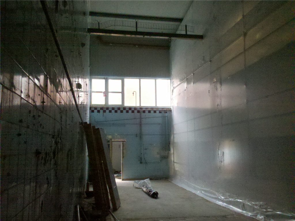 Temporary wall prior to the demolition of the end wall of the production facility. Gallery Image
