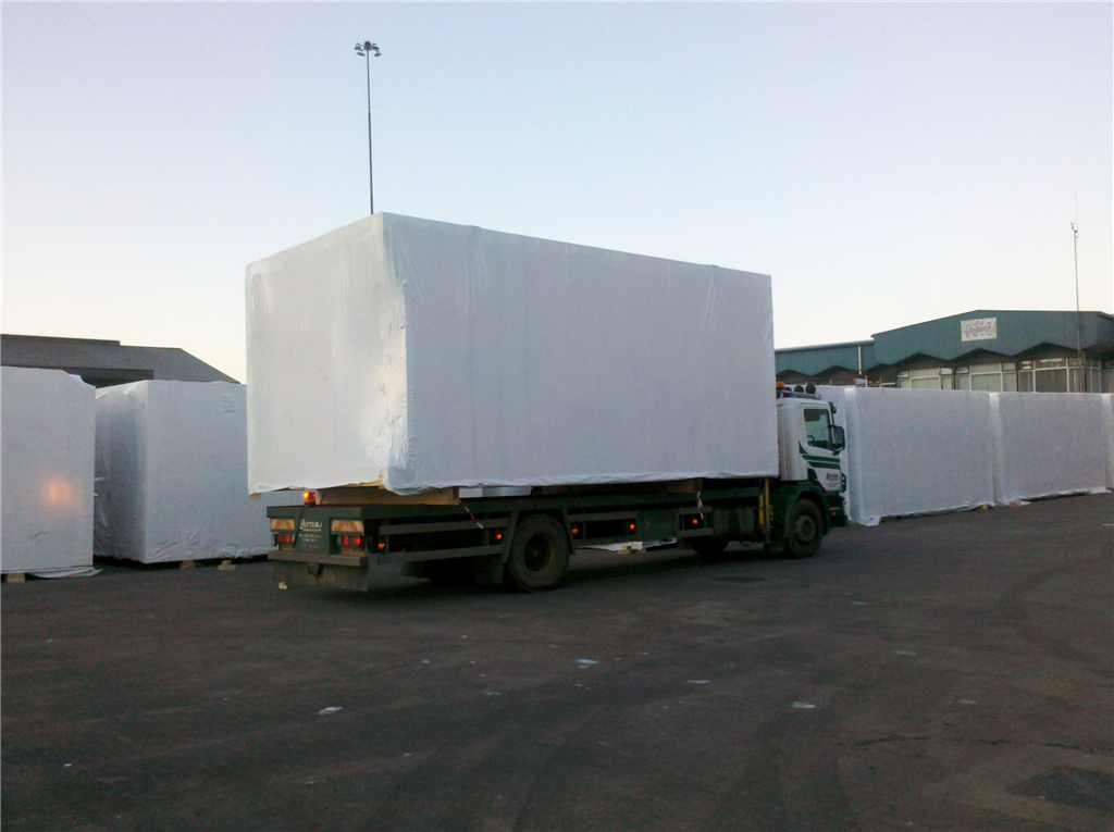 Prefabricated hotel bedrooms wrapping in Warrenpoint waiting for the ship to take them to the Scottish Isles. Gallery Image