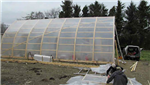 Bow roof shed covered with clear shrink film for use as a greenhouse. We make the bow roof sheds as well! Gallery Thumbnail