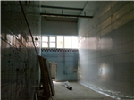 Temporary wall prior to the demolition of the end wall of the production facility. Gallery Thumbnail