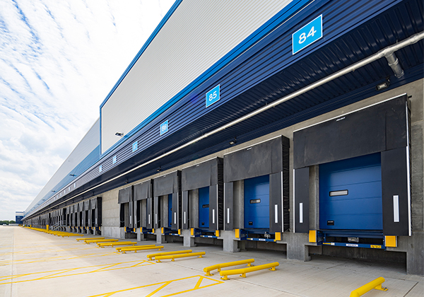 A row of loading dock bays, with dock leveller, dock door, wheel guides and dock shelter Gallery Image