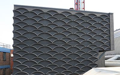  Bespoke 3-dimensional StoDeco shell profiles installed to the facade of London Olympia's new Energy Centre Gallery Image