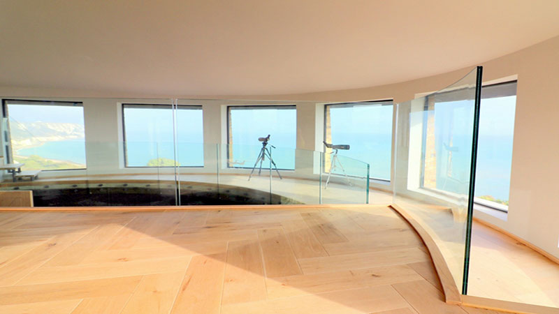 Frameless channel set glass balustrade protecting floor edge in Martello Tower Gallery Image