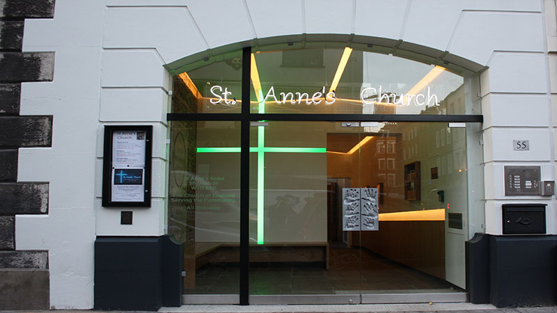 Award-winning design of arched glass doors set within black steel cross framing at St Anne's Church, Soho Gallery Image