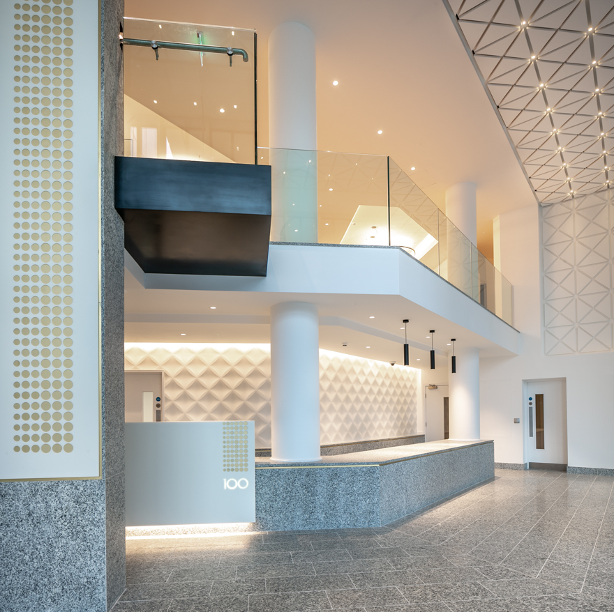 Serizzo Antigorio granite floor tiles, wall cladding and reception desk, Exchange Court, Manchester. Gallery Image