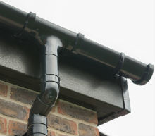 Black Ash woodgrain fascia with black Freeflow half-round gutters Gallery Image
